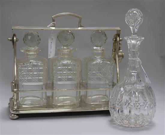 An electroplate three bottle tantalus and a decanter
